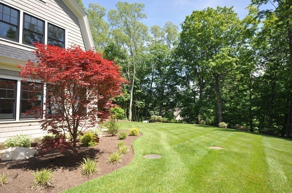 248 Nashawtuc Road Concord, MA 01742 - Photo 29 of 38 a backyard of a house with yard and outdoor seating