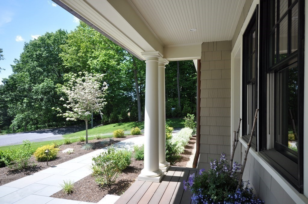 248 Nashawtuc Road Concord, MA 01742 - Photo 37 of 38 a view of backyard with potted plants and floor to ceiling window