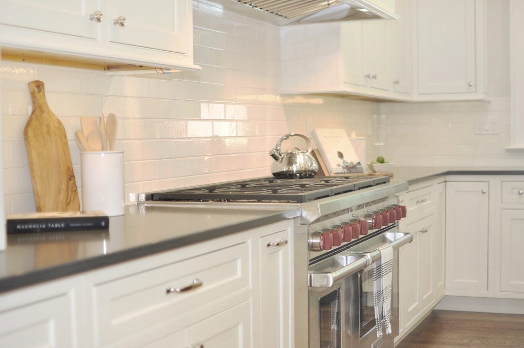 248 Nashawtuc Road Concord, MA 01742 - Photo 5 of 38 a kitchen with a stove and a white cabinets