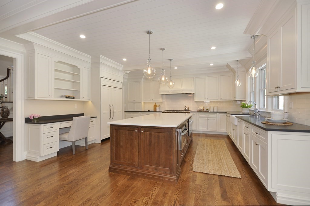 248 Nashawtuc Road Concord, MA 01742 - Photo 7 of 38 a large kitchen with stainless steel appliances kitchen island granite countertop a stove a sink and a refrigerator