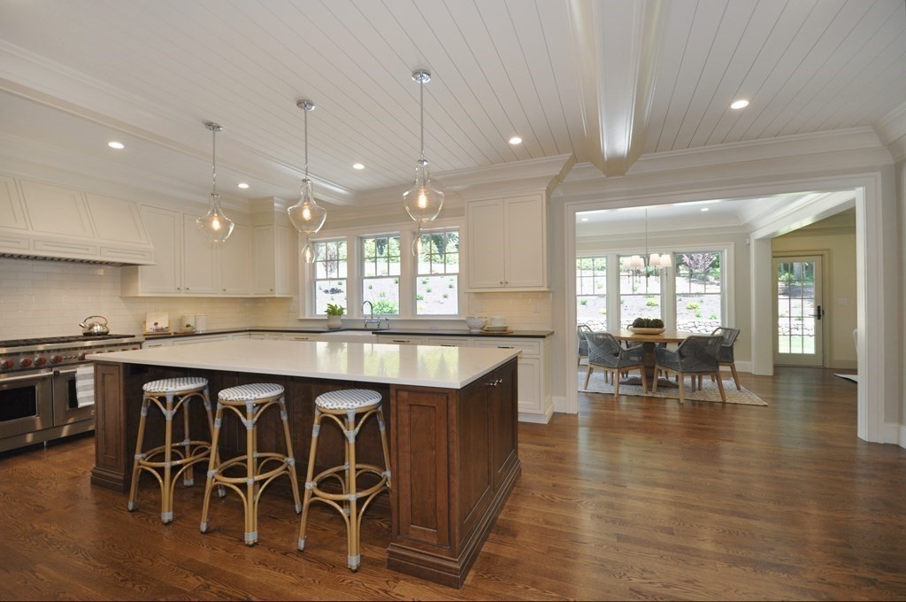 248 Nashawtuc Road Concord, MA 01742 - Photo 8 of 38 a large kitchen with a table and chairs
