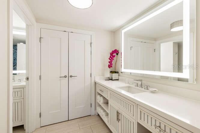 250 Sands Point Road, Unit 5203 Longboat Key, FL 34228 - Photo 11 of 32 a bathroom with a sink vanity and a mirror