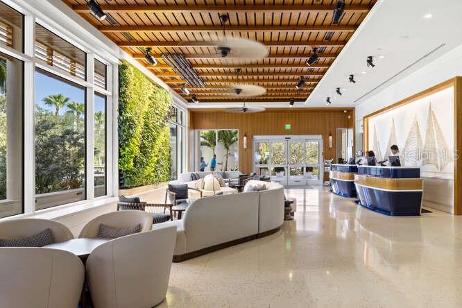 250 Sands Point Road, Unit 5203 Longboat Key, FL 34228 - Photo 19 of 32 a living room with furniture and a large window