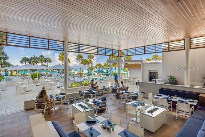 250 Sands Point Road, Unit 5203 Longboat Key, FL 34228 - Photo 20 of 32 a outdoor space with lots of tables a garden and chairs