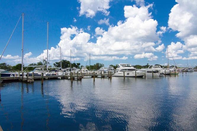 250 Sands Point Road, Unit 5203 Longboat Key, FL 34228 - Photo 31 of 32 a view of a lake with boats and trees in the background