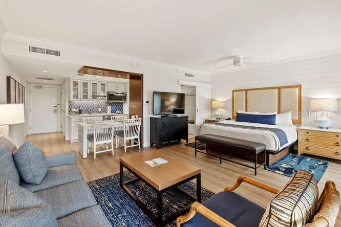 250 Sands Point Road, Unit 5203 Longboat Key, FL 34228 - Photo 5 of 32 a bedroom with furniture and a flat screen tv