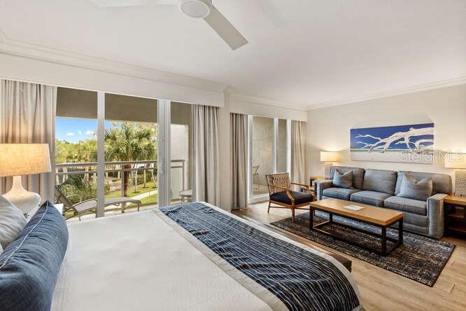 250 Sands Point Road, Unit 5203 Longboat Key, FL 34228 - Photo 6 of 32 a living room with furniture and a floor to ceiling window