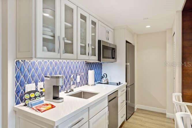 250 Sands Point Road, Unit 5203 Longboat Key, FL 34228 - Photo 10 of 32 a kitchen that has a sink and a stove in it