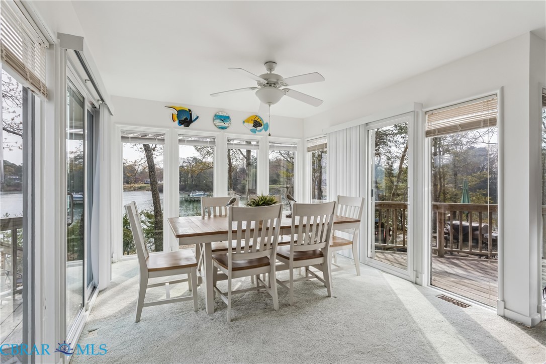 172 Sturgeon Creek Road Deltaville, VA 23043 - Photo 14 of 50 Sunroom with carpet floors and a water view