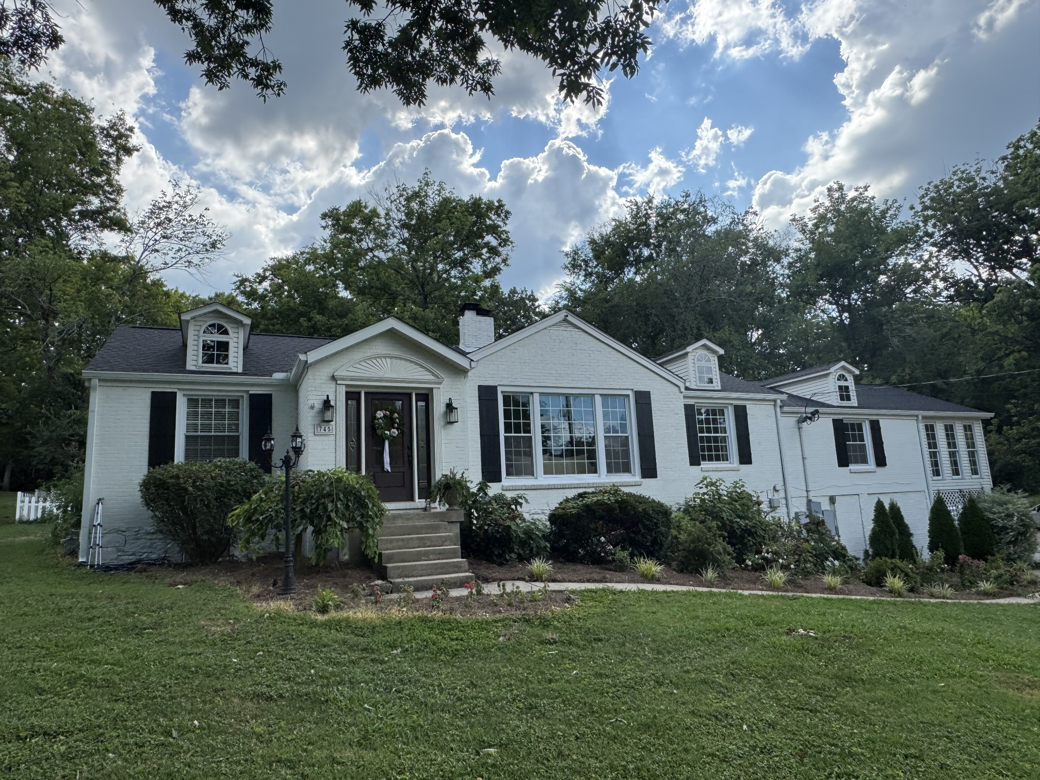 a front view of a house with a garden