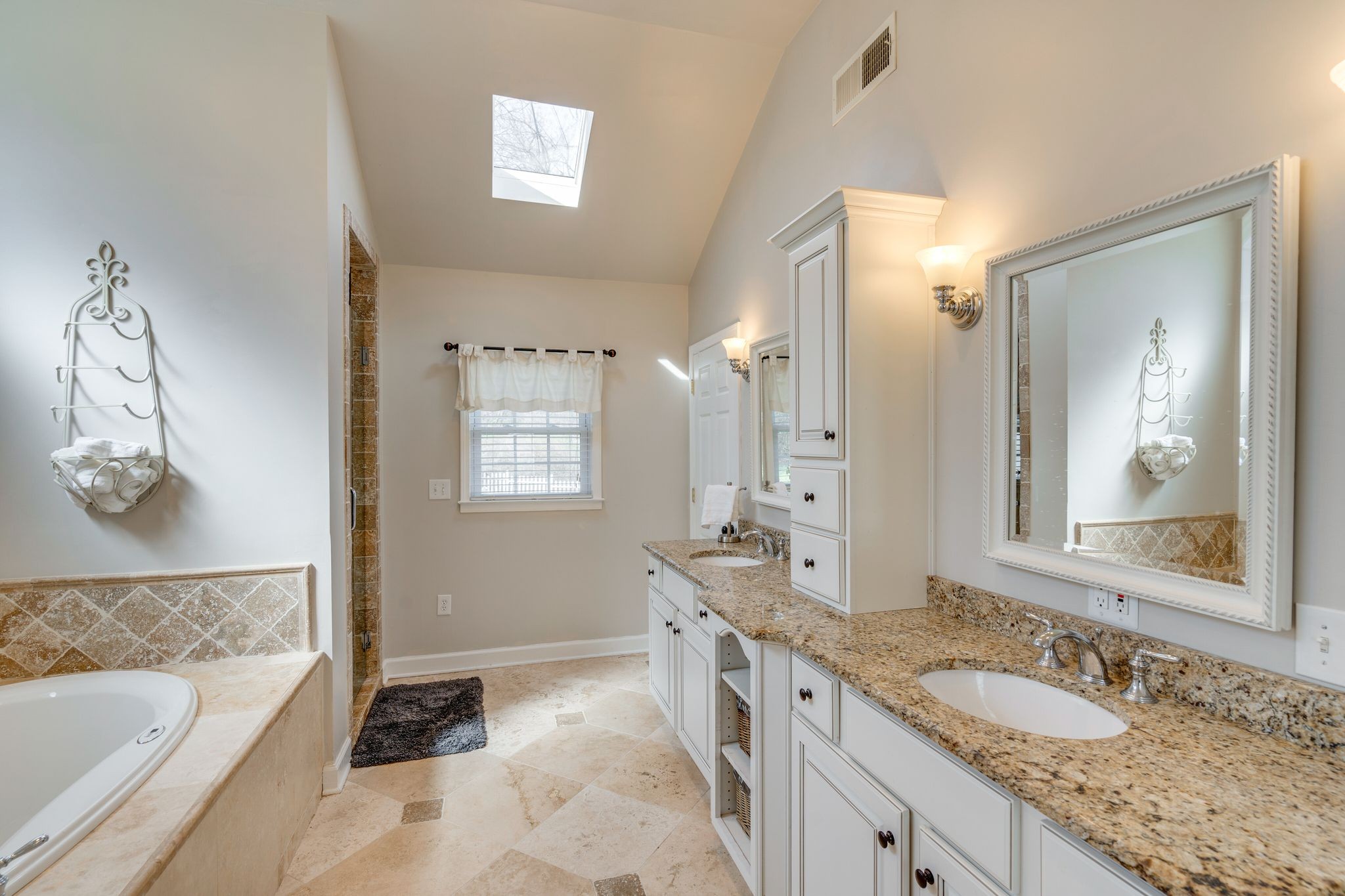 745 Elysian Fields Road Nashville, TN 37204 - Photo 31 of 60 a spacious bathroom with a granite countertop tub sink and mirror