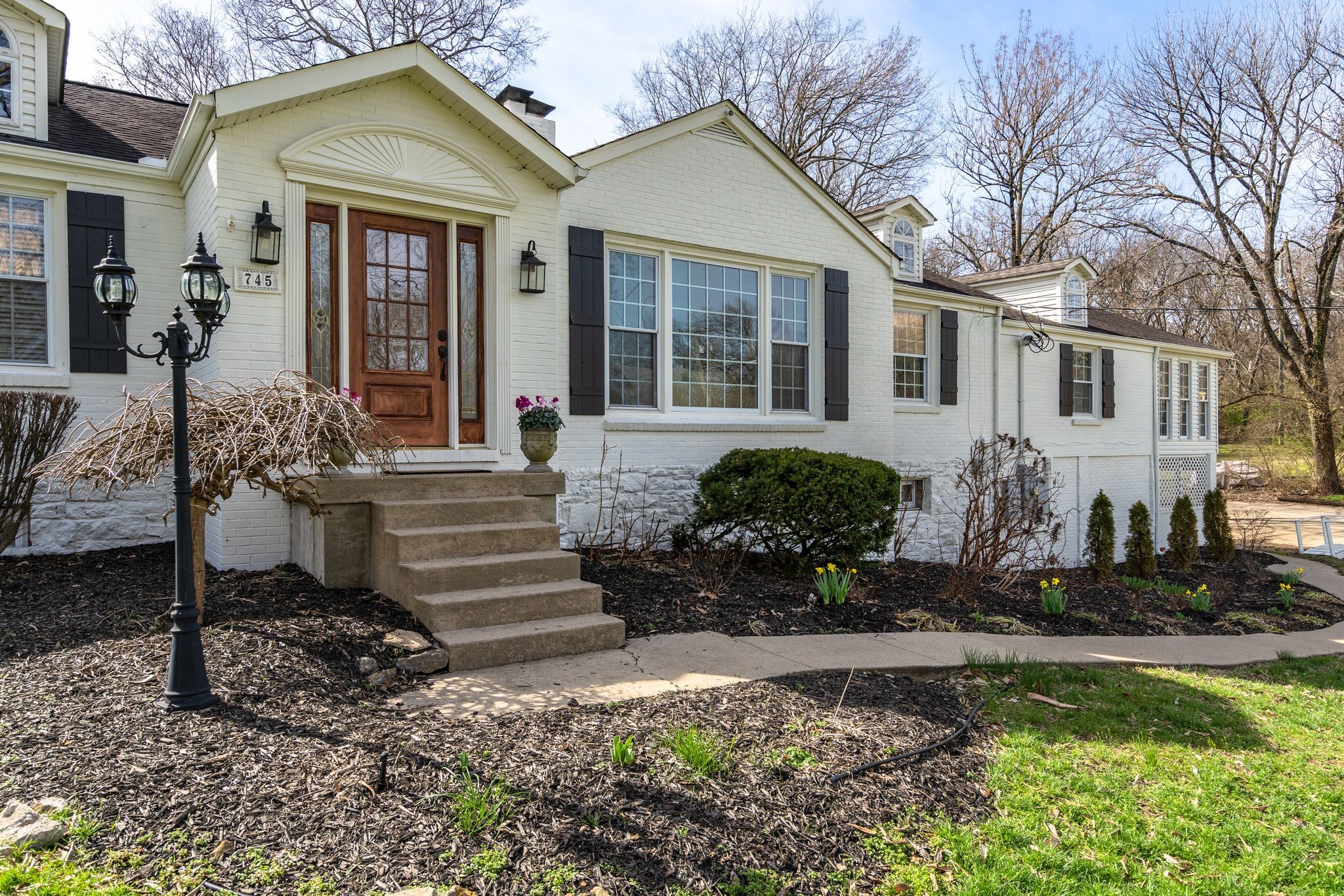 745 Elysian Fields Road Nashville, TN 37204 - Photo 4 of 60 a front view of a house with garden