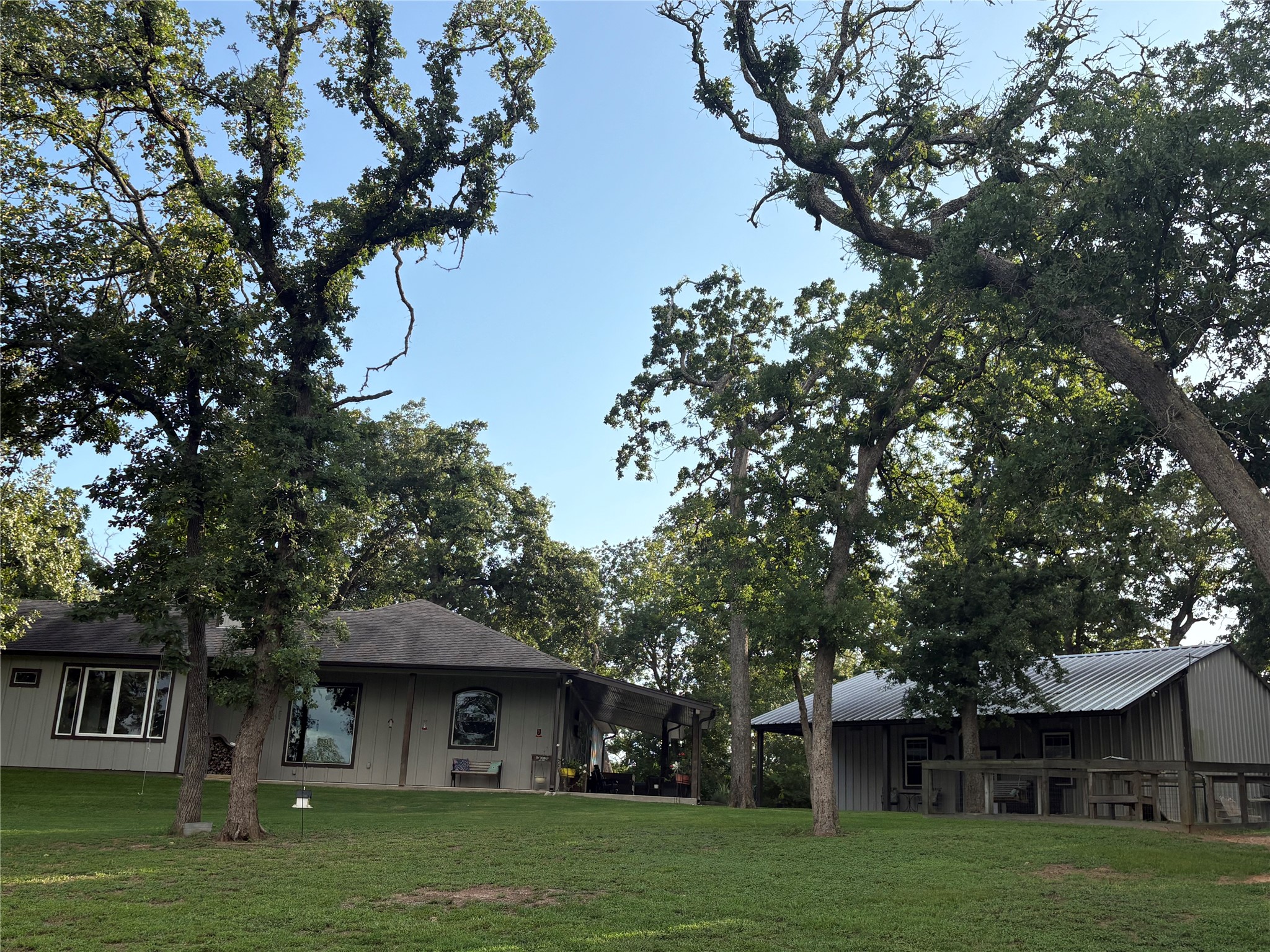 8595 Jared Road Bellville, TX 77418 - Photo 4 of 30 Backyard view of this wonderful home that offers a great place to sit and enjoy the view...custom windows also allow a glimpse of nature whether you're inside or out