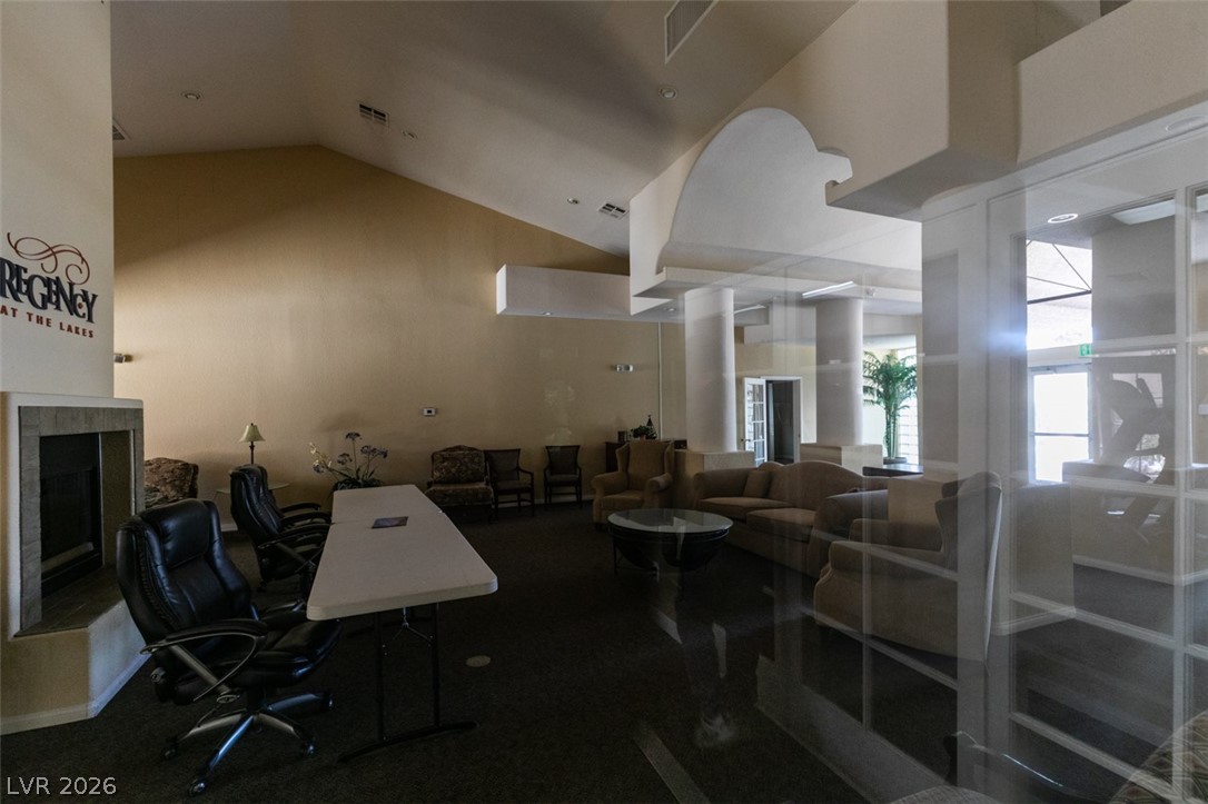 9325 West Desert Inn Road, Unit 244 Las Vegas, NV 89117 - Photo 44 of 55 A spacious common area with vaulted ceilings and a cozy fireplace, perfect for gatherings.