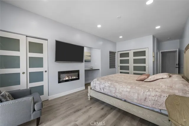 a bedroom with a bed and a fireplace