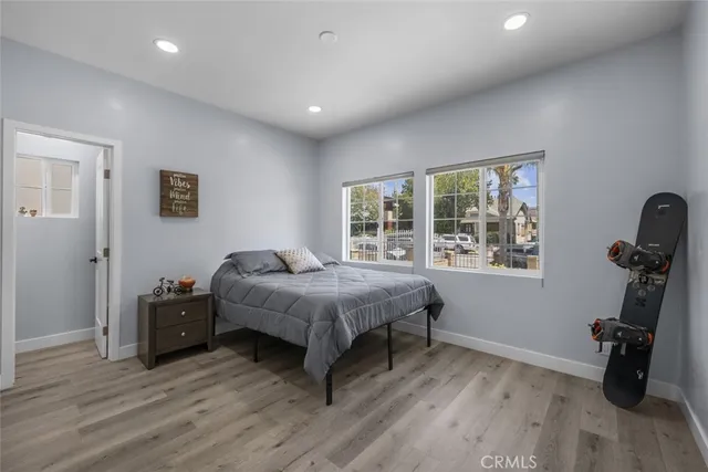 a bedroom with a bed and wooden floor