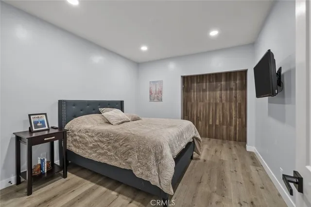 a bedroom with a bed and a flat screen tv