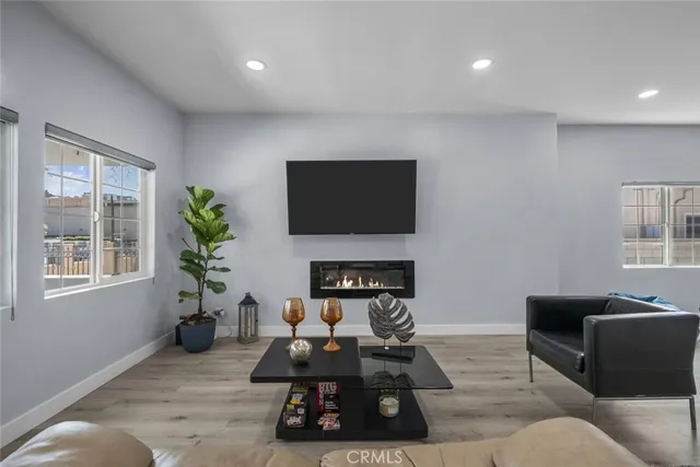 a living room with furniture a fireplace and a flat screen tv