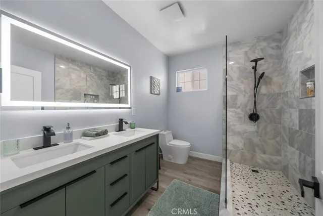 a bathroom with a sink toilet and shower