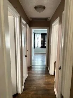 an empty room with a ceiling fan and wooden floor