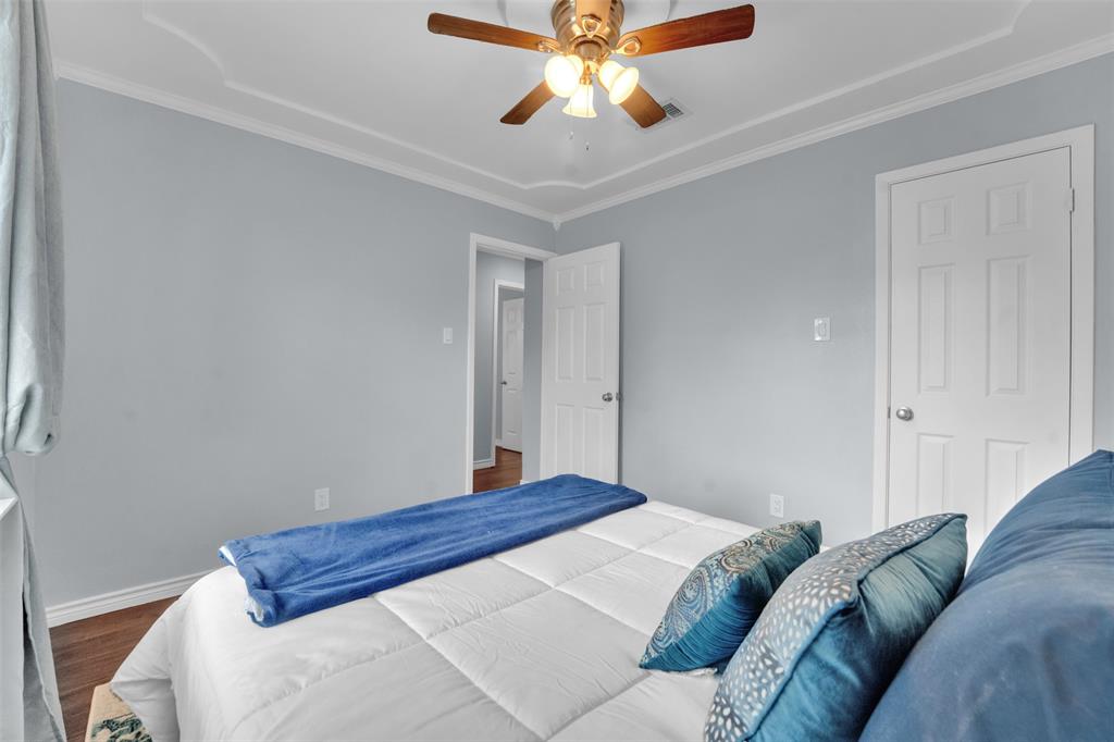 1008 Kay Lynn Street Mansfield, TX 76063 - Photo 13 of 21 a bedroom with a bed and a chandelier