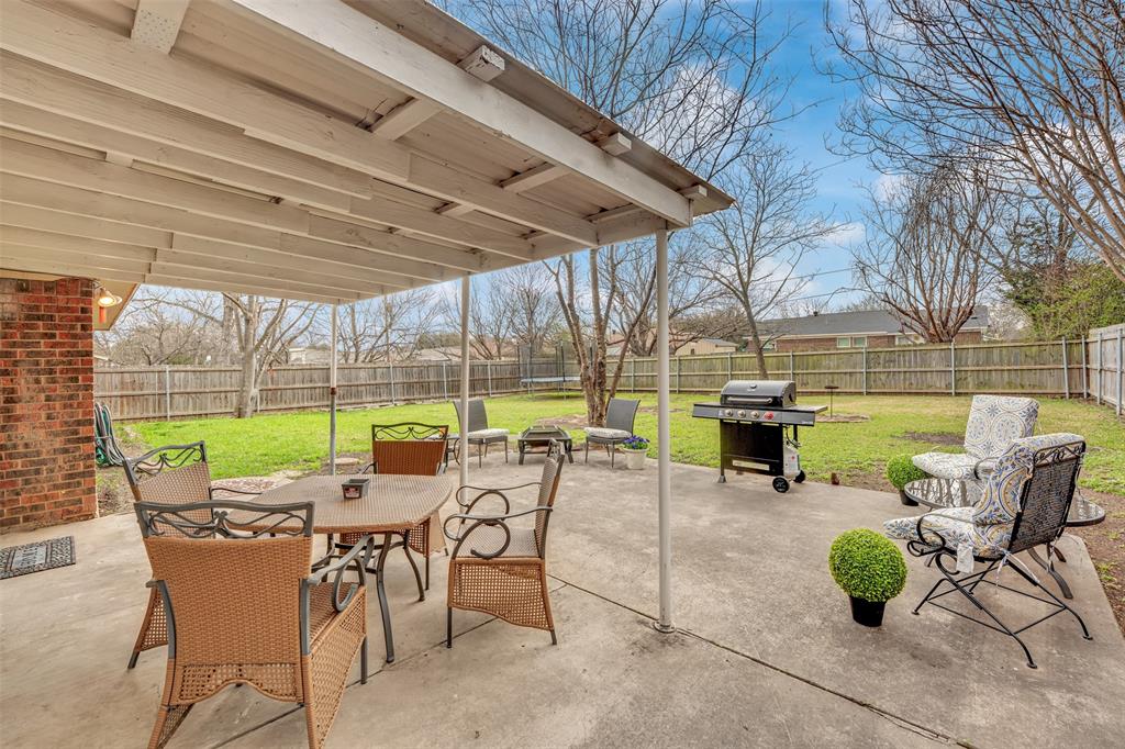 1008 Kay Lynn Street Mansfield, TX 76063 - Photo 20 of 21 a view of a patio with chairs and table under an umbrella