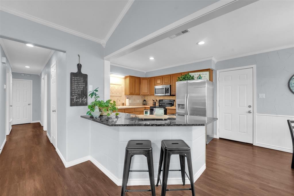 1008 Kay Lynn Street Mansfield, TX 76063 - Photo 8 of 21 a kitchen with stainless steel appliances granite countertop a stove a refrigerator and a microwave