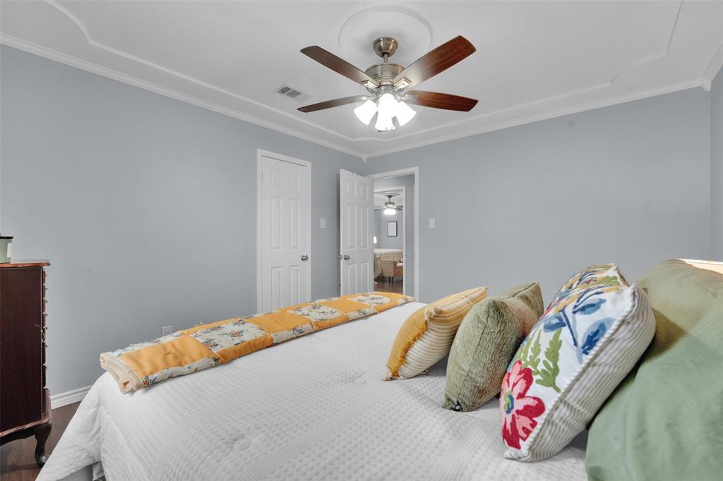 1008 Kay Lynn Street Mansfield, TX 76063 - Photo 10 of 21 a bedroom with a bed and a chandelier