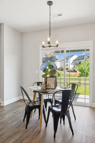an empty room with closet and a chandelier fan