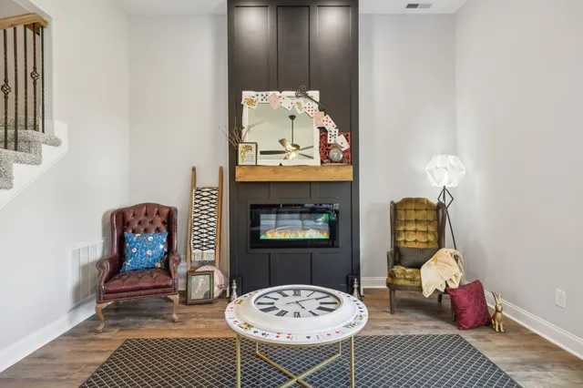 a kitchen with kitchen island granite countertop a sink cabinets and wooden floor