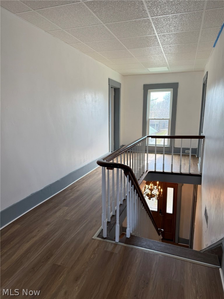 23033 Cadiz Road Freeport, OH 43973 - Photo 18 of 31 Staircase featuring wood finished floors and a paneled ceiling