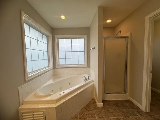 a bathroom with a bathtub and a shower