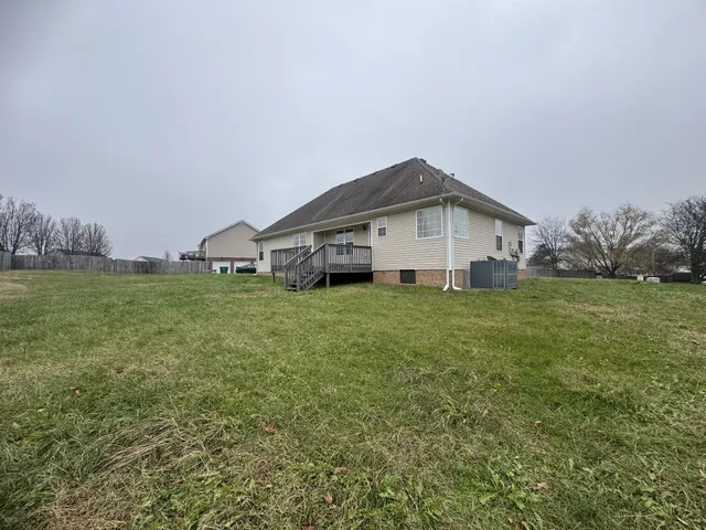 a view of a house with a yard and garage