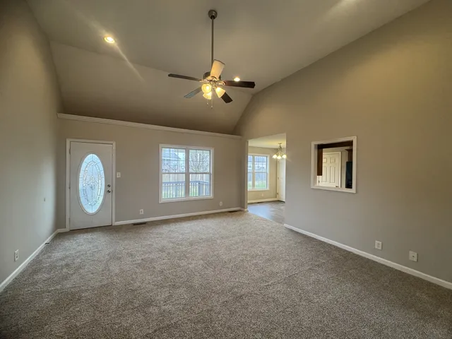 a view of a livingroom with a ceiling fan and window