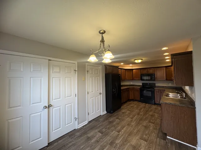a kitchen with a refrigerator and a stove top oven