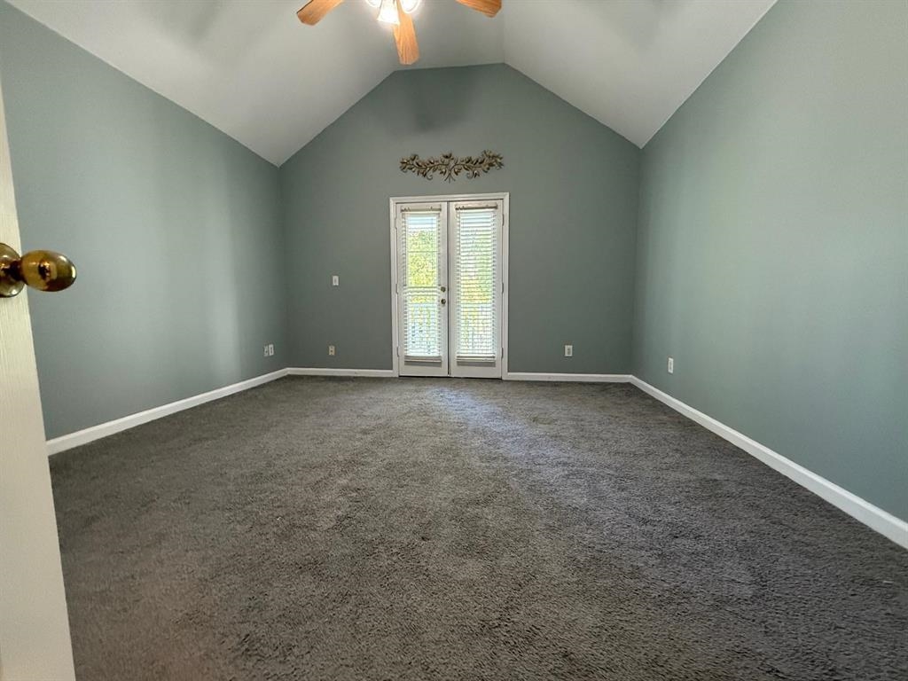 1173 Island Place East Memphis, TN 38103 - Photo 11 of 18 Spare room with a ceiling fan, dark colored carpet, a high ceiling, and french doors