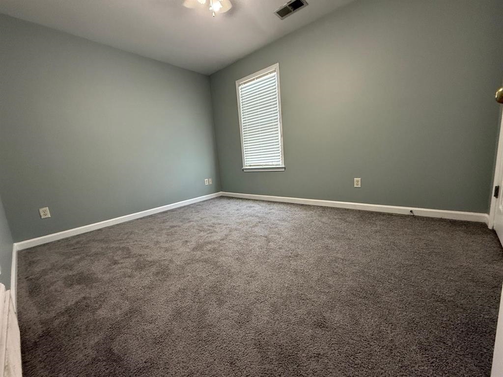1173 Island Place East Memphis, TN 38103 - Photo 13 of 18 Empty room featuring dark colored carpet and baseboards
