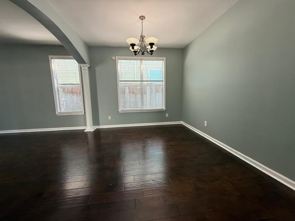 1173 Island Place East Memphis, TN 38103 - Photo 5 of 18 Spare room featuring hanging lights, arched walkways, and dark wood-style floors