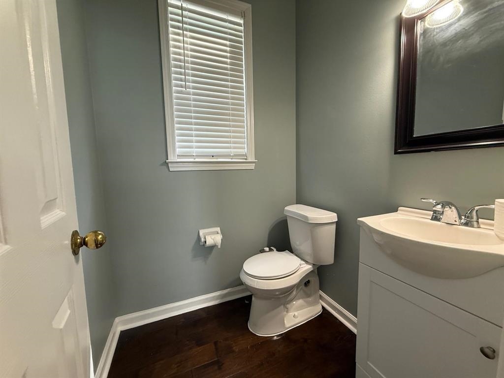 1173 Island Place East Memphis, TN 38103 - Photo 8 of 18 Half bathroom featuring vanity and dark wood-style flooring
