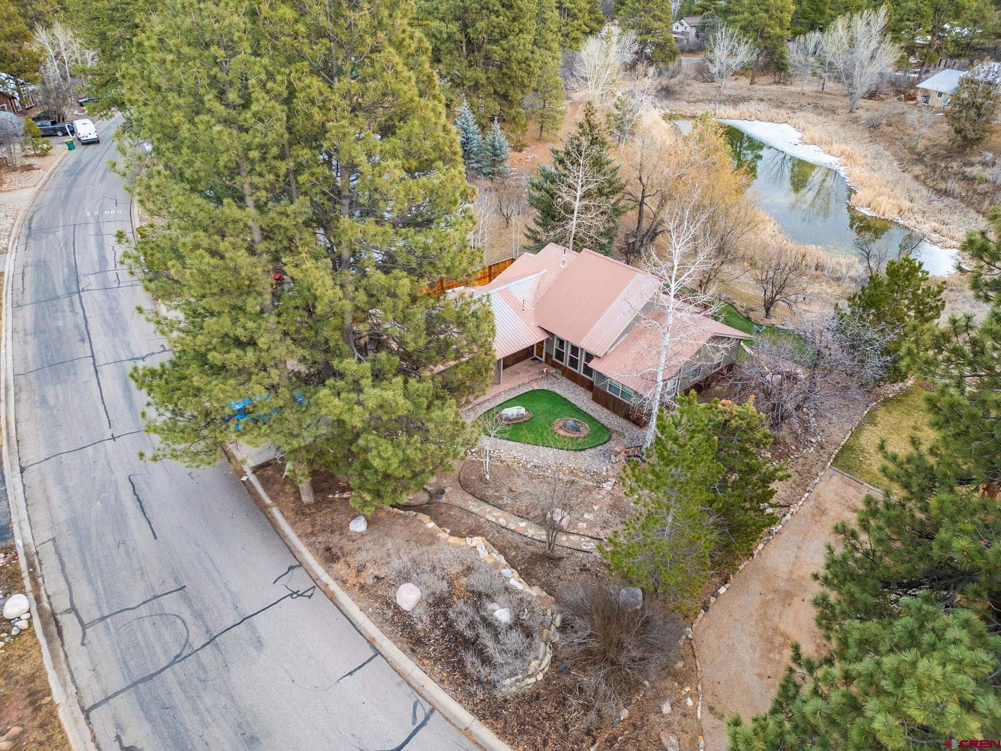 136 Oak Drive Durango, CO 81301 - Photo 1 of 29 an aerial view of a house with a yard and trees
