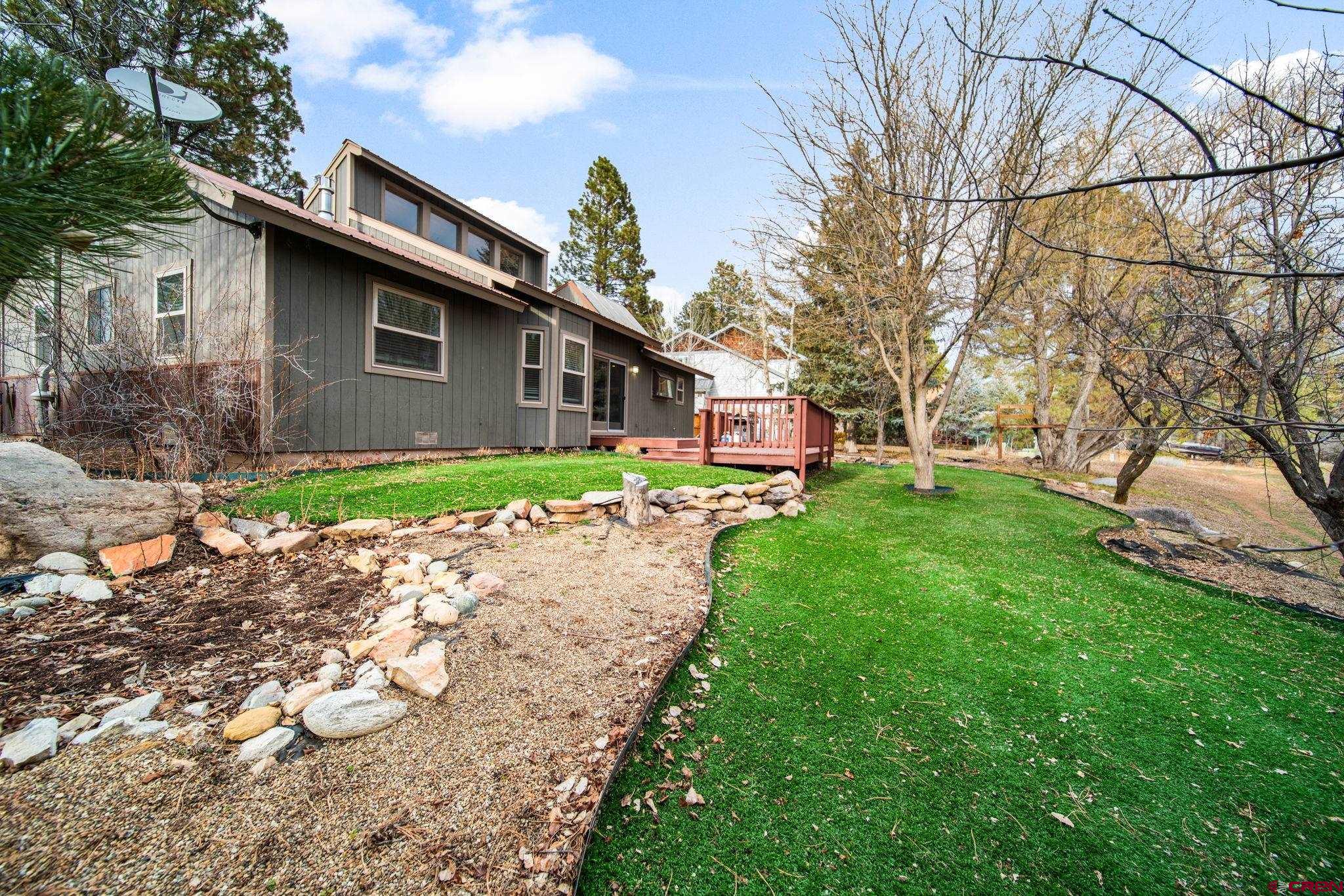 136 Oak Drive Durango, CO 81301 - Photo 23 of 29 a front view of a house with garden