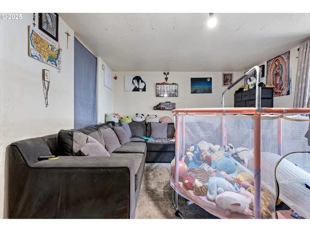 a living room filled with furniture and a flat screen tv