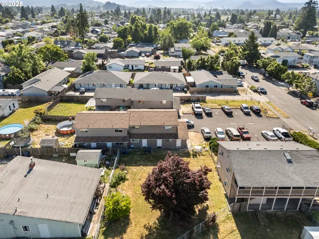 an aerial view of residential houses with yard