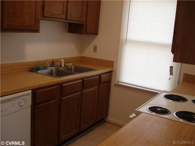 4452 Baxter Road Prince George, VA 23875 - Photo 2 of 4 a kitchen with a sink a stove and a window
