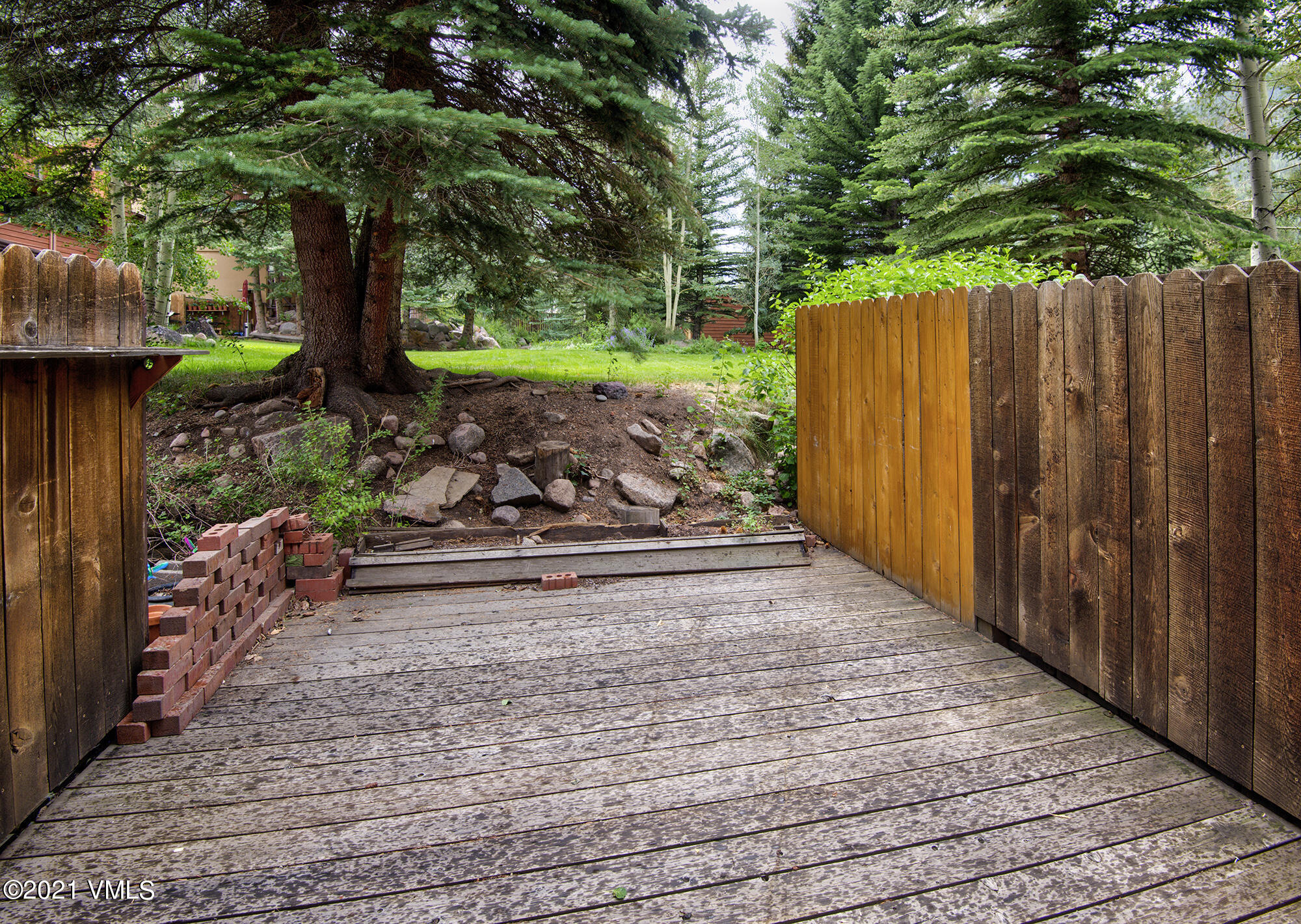 4506 Spruce Way, Unit 4 Vail, CO 81657 - Photo 20 of 31 a view of a backyard with plants and large trees