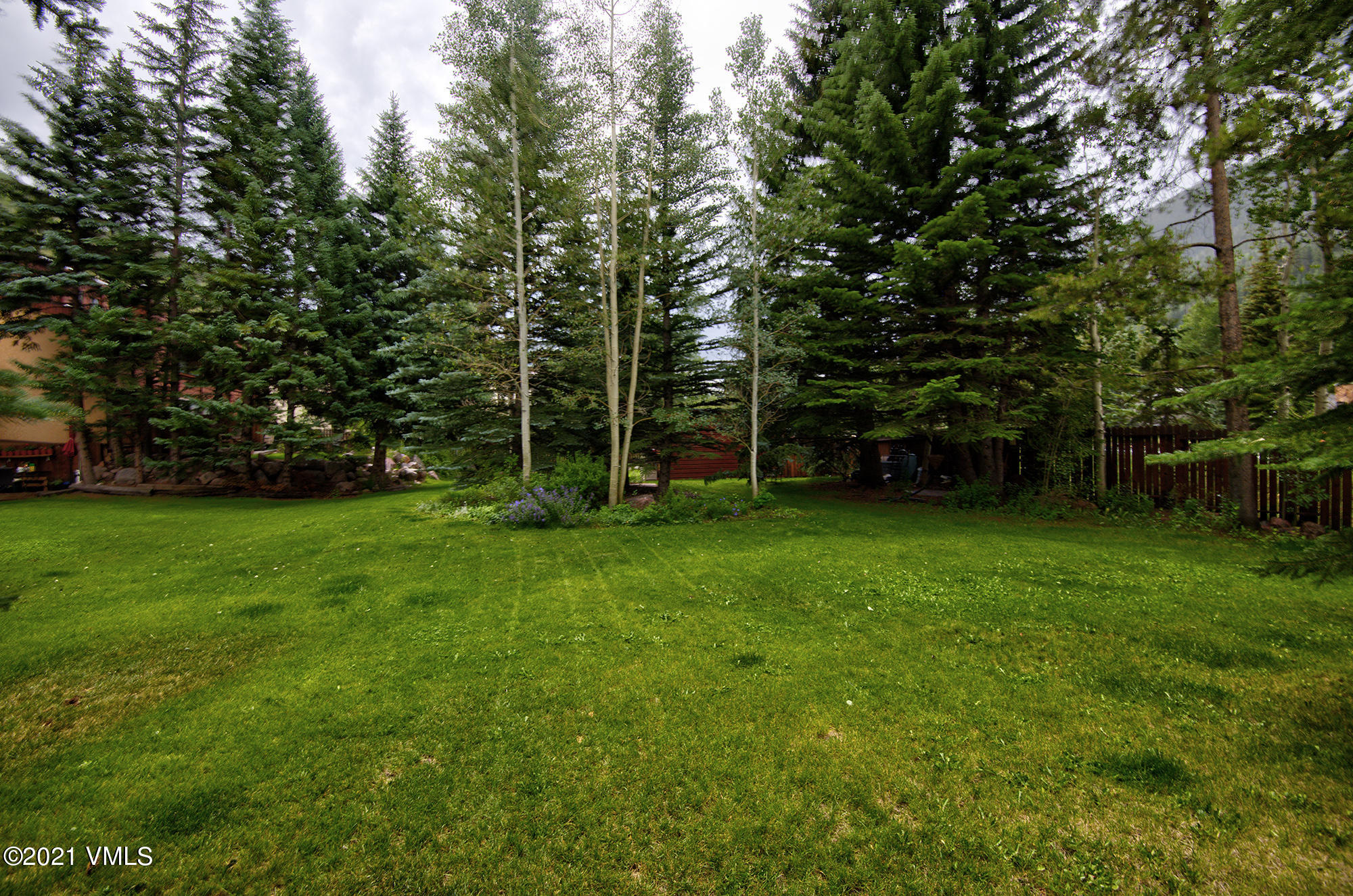 4506 Spruce Way, Unit 4 Vail, CO 81657 - Photo 21 of 31 a view of green field with trees in the background