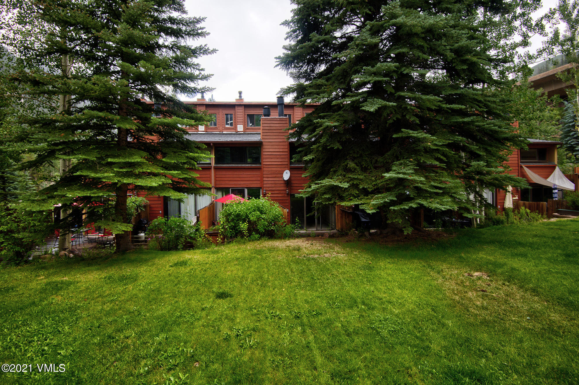 4506 Spruce Way, Unit 4 Vail, CO 81657 - Photo 22 of 31 a view of a play house with a yard and plants