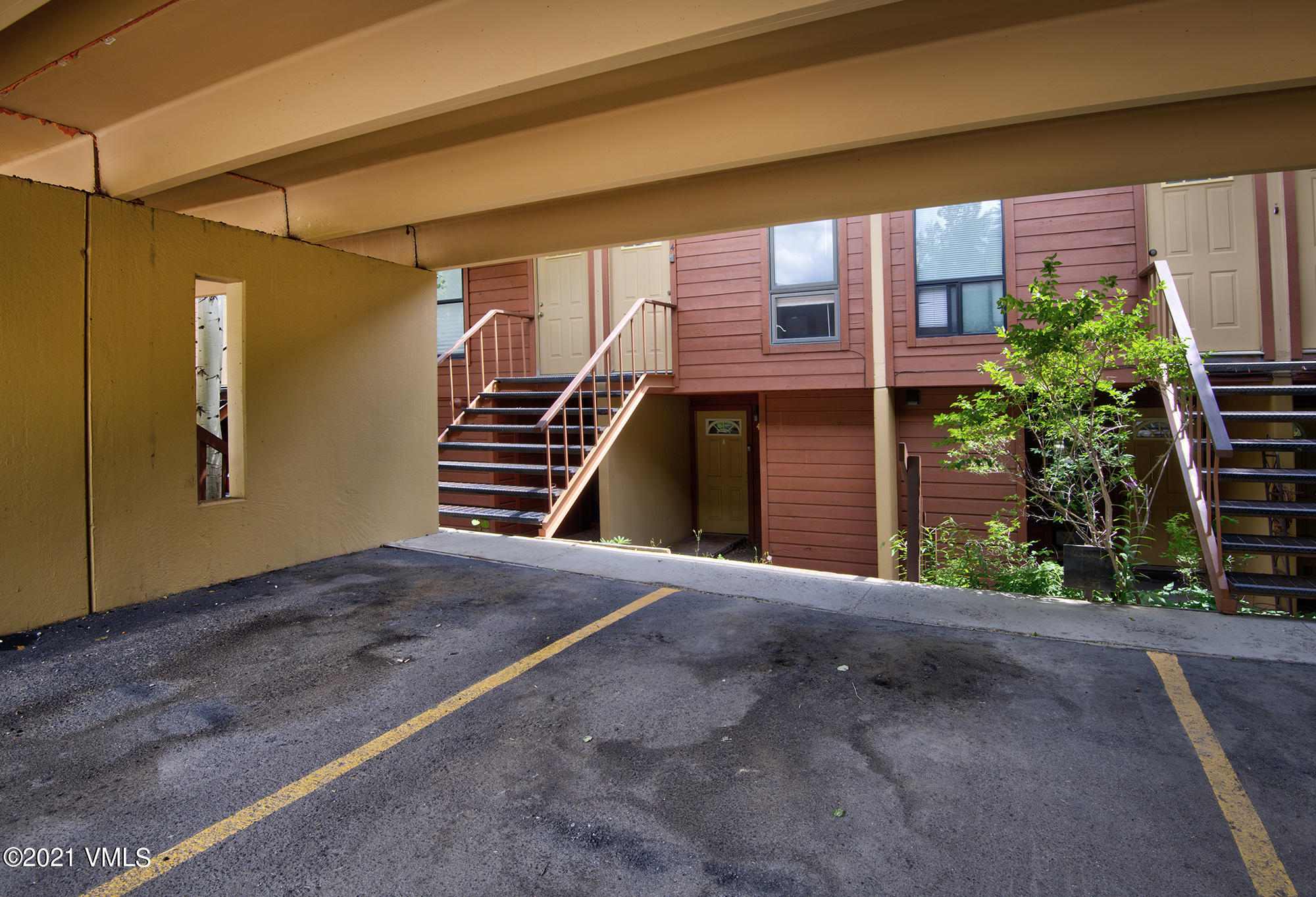 4506 Spruce Way, Unit 4 Vail, CO 81657 - Photo 24 of 31 a front view of a house with a yard