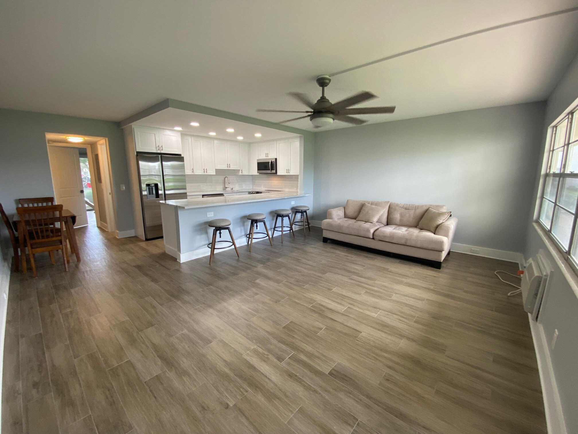342 Mansfield Drive, Unit I Boca Raton, FL 33434 - Photo 2 of 17 a living room with furniture and a large window