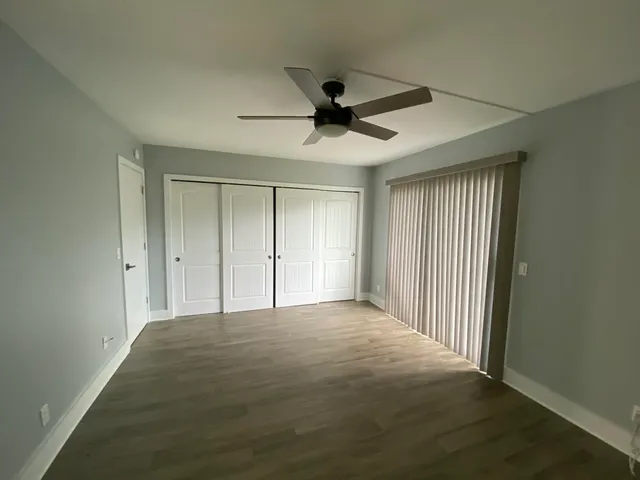 a view of a livingroom with a ceiling fan and window